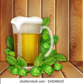 beer and hop on a wooden background