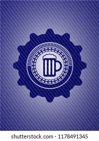 beer jar icon inside badge with denim texture