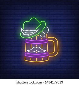 Beer mug with hat and moustache neon sign. Brasserie, sport bar Oktoberfest, St. Patrick's Day. Night bright advertisement. Vector illustration in neon style for pub banners and advertising
