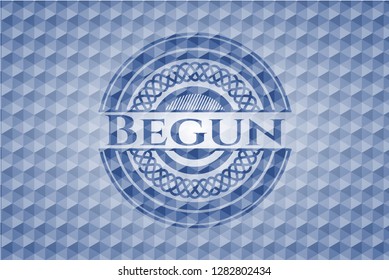 Begun blue badge with geometric background.