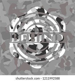 Behind grey camouflage emblem