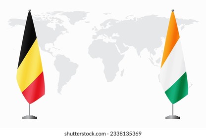 Belgium and Ivory Coast flags for official meeting against background of world map.