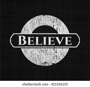 Believe chalk emblem written on a blackboard