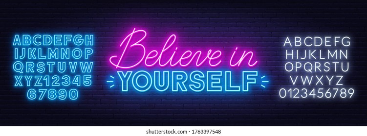 Believe in yourself neon inspirational quote on a brick wall.