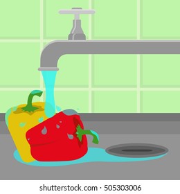 Bell peppers being cleaned and washed in a sink in a kitchen. Running tap water.