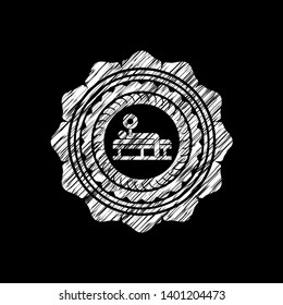 bench press icon inside chalkboard emblem on black board