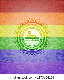 bench press icon inside emblem on mosaic background with the colors of the LGBT flag