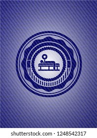 bench press icon inside emblem with jean background