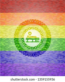 bench press icon inside emblem on mosaic background with the colors of the LGBT flag