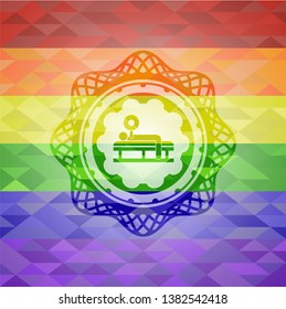bench press icon inside emblem on mosaic background with the colors of the LGBT flag