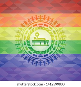 bench press icon inside emblem on mosaic background with the colors of the LGBT flag