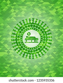 bench press icon inside green emblem with triangle mosaic background