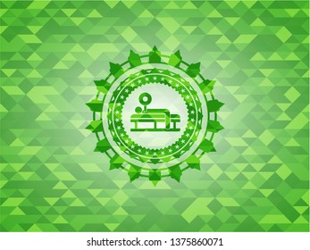 bench press icon inside green emblem with triangle mosaic background