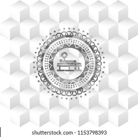 bench press icon inside grey badge with geometric cube white background