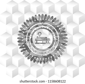 bench press icon inside grey emblem with geometric cube white background