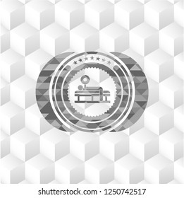 bench press icon inside grey badge with geometric cube white background