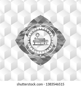 bench press icon inside grey badge with geometric cube white background