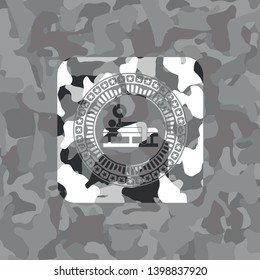 bench press icon inside grey camouflage emblem