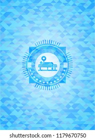 bench press icon inside light blue mosaic emblem