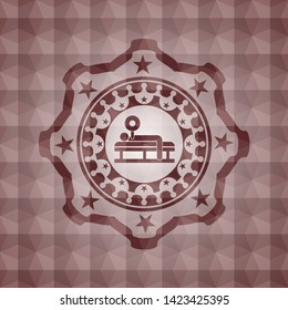 bench press icon inside red seamless emblem with geometric pattern background.