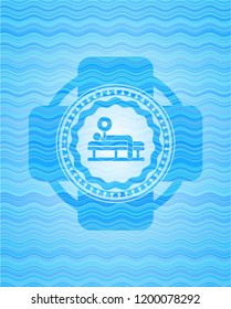 bench press icon inside sky blue water wave emblem.