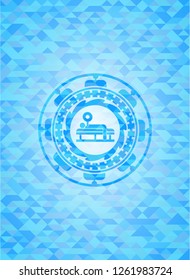 bench press icon inside sky blue emblem with triangle mosaic background