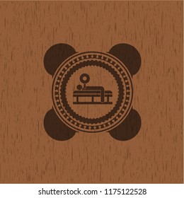 bench press icon inside wooden emblem