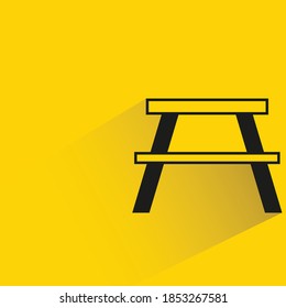 bench with shadow on yellow background