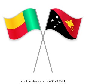 Beninese and Papuan crossed flags. Benin combined with Papua New Guinea isolated on white. Language learning, international business or travel concept.