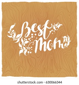 best mom.Design lettering hand draw.Wood texture background In the background texture of wood. Drawing white text