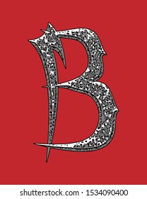 Beveled letter with coarse surface on red background.