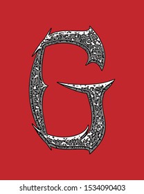 Beveled letter with coarse surface on red background.