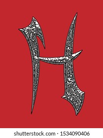 Beveled letter with coarse surface on red background.