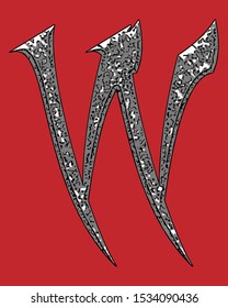 Beveled letter with coarse surface on red background.