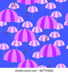 Bi colors, two sizes bi color pink and mauve umbrellas. Seamless pattern on blue color background.