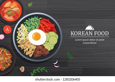 Bibimbap in the bowl on black wood table top view. Korea food background.