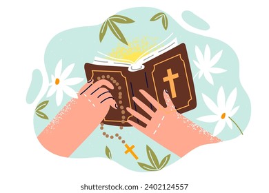 Bible with christian crucifix in hands of man studying catholic canons from books describing gospel. Flowers around holy bible or prayer book for development spirituality and search for meaning life