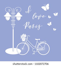 Bicycle with a basket of flowers, lantern, butterflies. The inscription I love Paris. Travel and leisure.