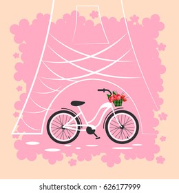 Bicycle with a basket of flowers on the background of the Eiffel Tower