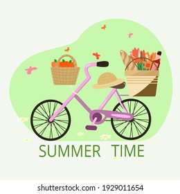 A bicycle and everything for a picnic on it. The inscription summer time and everything on the background of a summer meadow