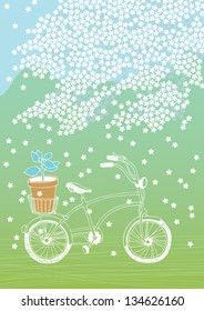 Bicycle with flowerpot and white blooming tree