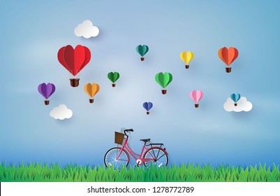 Bicycle in the garden with colorful hot air balloon heart shap. paper art 3d from digital craft.