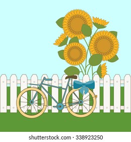Bicycle on the background of the fence and sunflowers