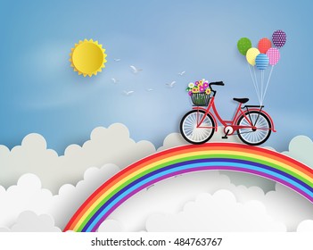 Bicycle riding on a rainbow with blue sky.paper at style.