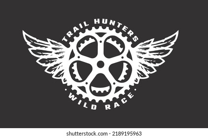 Bicycle star and wings, trail hunter symbol, logo on a dark background.