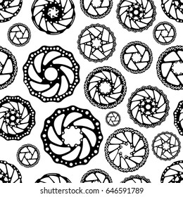 Bicycles. Seamless vector pattern with bicycle parts. Brake disks of mountain, sports bicycles.