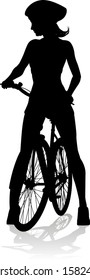 Bicyclist riding their bike and wearing a safety helmet in silhouette