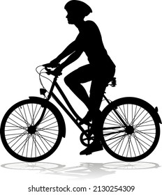 Bicyclist riding their bike and wearing a safety helmet in silhouette