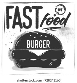 A big chalk black burger with letting on it. White background