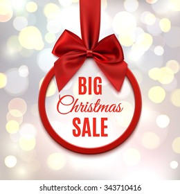 Big Christmas sale, round banner with red ribbon and bow, on abstract, blurred background with bokeh circles. Vector illustration.